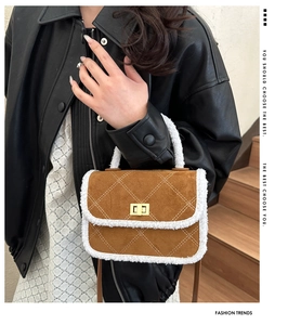 Detail of caramel suede crossbody bag with fleece trim and diamond quilted stitching