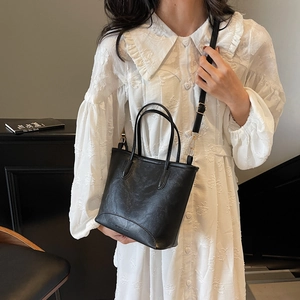 Litchi pattern black bucket bag with top handle and adjustable shoulder strap