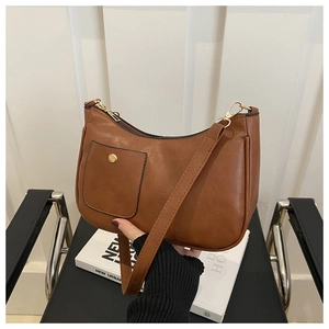 Détail d'un sac hobo marron avec petite poche avant et fermeture à glissière dorée