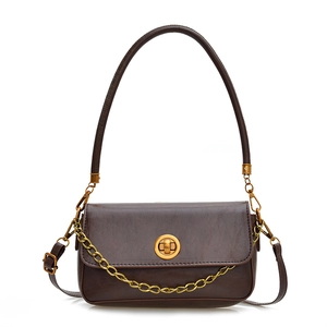 Sac bandoulière marron rétro avec chaîne dorée et fermoir pivotant sur fond blanc