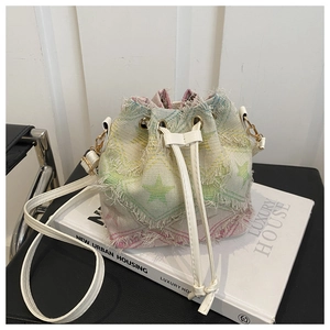 Detail of colorful tassel bucket bag with green star pattern and drawstring closure
