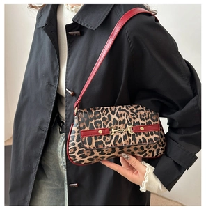 Detail of leopard print shoulder bag with red strap and golden horsebit hardware