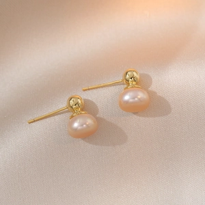 Elegant S925 silver needle champagne pearl stud earrings on luxury silk background