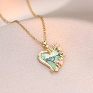 Gouden hart ketting met abalone schelp, strik detail en schitterende kristallen