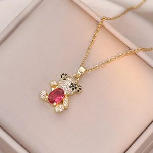 Chic gold teddy bear necklace with pave zircon stones and a red oval gem centerpiece