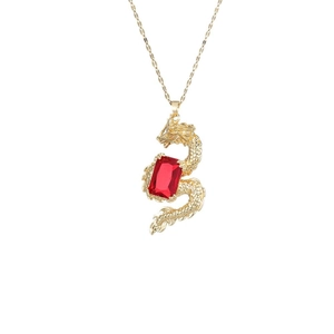 Golden dragon pendant necklace with red gemstone and intricate scale engravings