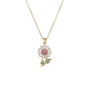 Collier tournesol doré avec cristal rose et feuilles en zircon vert sur fond blanc