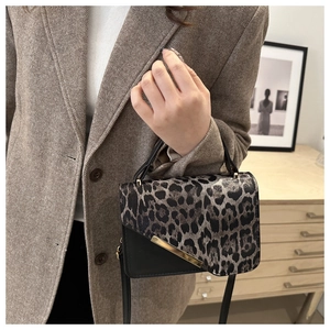 Chic leopard print flap shoulder bag with gold metal trim and black leather finish