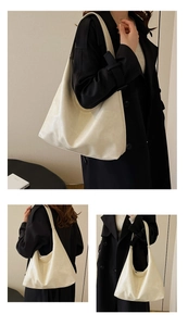 Detailed view of creamy white tote bag with soft PU leather folds and shoulder strap
