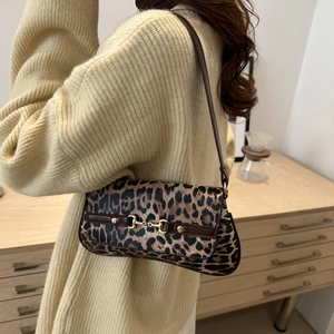 Retro leopard print baguette bag with gold horsebit buckle shown on a model