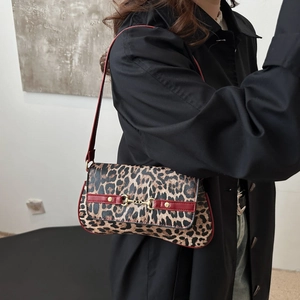 Chic leopard print underarm bag with red contrast straps and golden horsebit detail