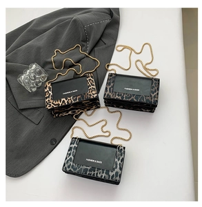 Detailed close-up of fashion leopard print crossbody bags with elegant gold chain straps