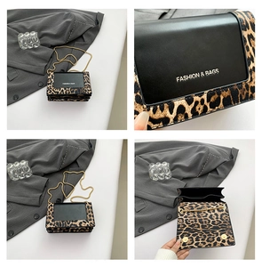Detail view of leopard print chain bag with gold hardware and multi-compartment interior