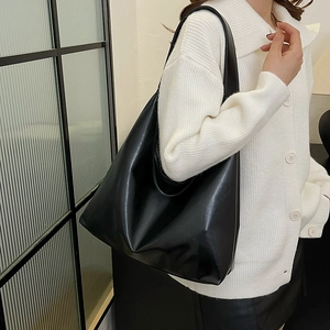 Minimalist black large-capacity PU leather tote bag shown in a classic daily commuter style
