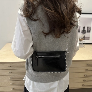 Elegant black patent leather crossbody bag with silver bead trim and chain strap for women