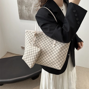 Retro grey monogram tote bag with matching pouch on model in formal black suit
