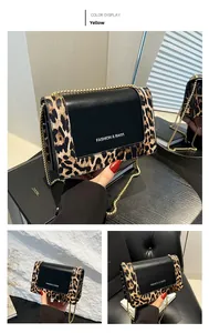 Detail of the leopard print contrast bag with gold chain strap and magnetic snap closure