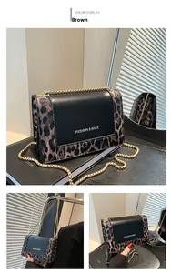 Detail of brown leopard print crossbody bag with gold chain and black leather flap