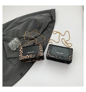 Detail of leopard print拼接 chain bags with Fashion & Bags lettering on white background