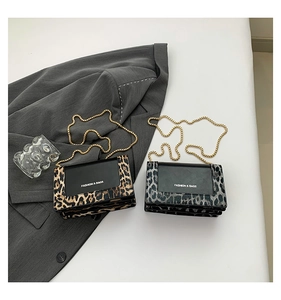 Detail of leopard print patchwork chain bags with gold strap and fashion logo