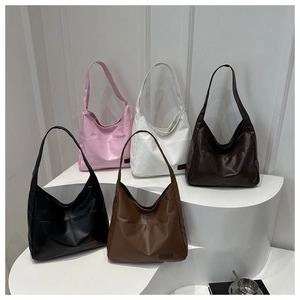 Collection de grands sacs cabas en similicuir en cinq couleurs sur présentoirs géométriques