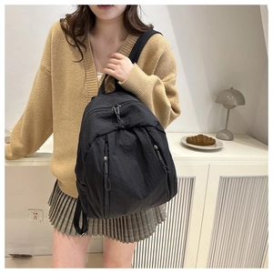 Detail of high-density nylon backpack showing smooth zipper and minimalist daily look