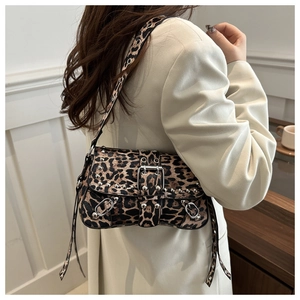 Detail of leopard print shoulder bag with silver rivets and metal buckle hardware