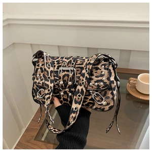 Close-up of leopard print shoulder bag with silver eyelets and Y2K aesthetic