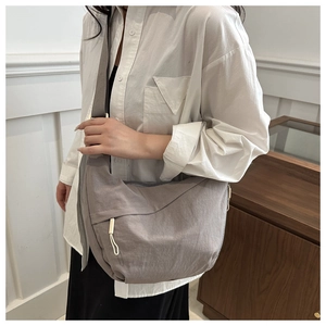 Detailed close-up of large capacity grey nylon crescent bag with adjustable wide strap