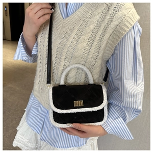Close-up of contrast crossbody bag with black quilted suede and white faux fur trim