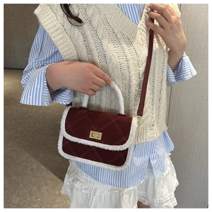 Detail of burgundy crossbody bag with sherpa trim and vintage quilted pattern