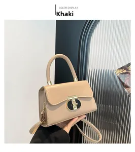Detail of khaki fashion square bag with gold T-shaped lock and detachable shoulder strap