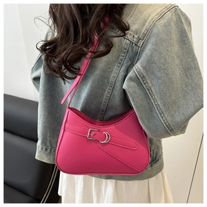 Magenta crescent shoulder bag detail with silver buckle on premium leather surface
