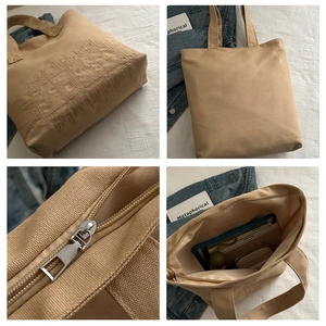 Detailed views of khaki canvas tote with artistic embroidery, zipper, and spacious interior