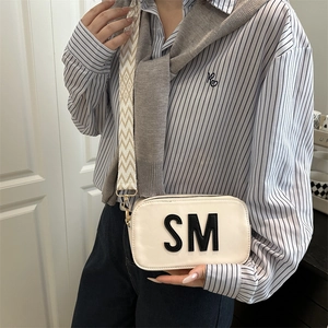 Cream square camera bag with SM letter detail and geometric pattern wide shoulder strap