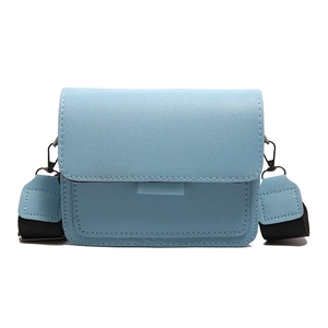 Sky blue crossbody bag for women with grain texture leather and a wide shoulder strap