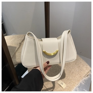 Detail of cream shoulder bag featuring a smooth texture and a golden moon metal buckle