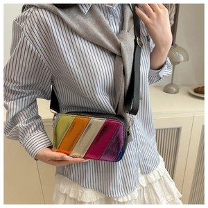 Close-up of rainbow metallic quilted crossbody camera bag with wide nylon strap