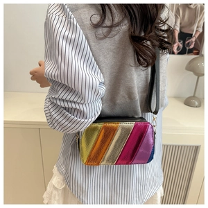 Macro view of colorful metallic texture and diagonal rainbow stripes on crossbody bag
