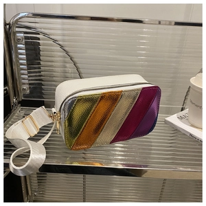 Close-up of rainbow metallic stripes on white lychee leather shoulder bag with gold zipper