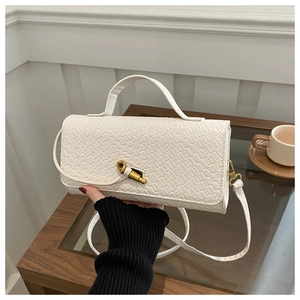 Detailed view of white crocodile pattern shoulder bag with elegant gold metal twist lock