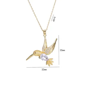 Golden hummingbird pendant necklace with teardrop crystal and cubic zirconia stones