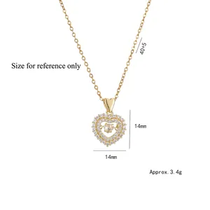 Collier avec pendentif coeur doré orné de diamants et chaîne croisée ajustable élégante