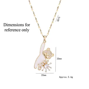 Gold-plated bear necklace with white shell moon and rotating flower pendant on flat chain