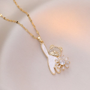 Golden necklace with a cute white teddy bear pendant holding a zircon-encrusted flower