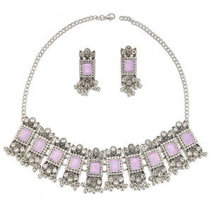 Macro view of vintage silver jewelry set with purple gemstones and rhinestone accents