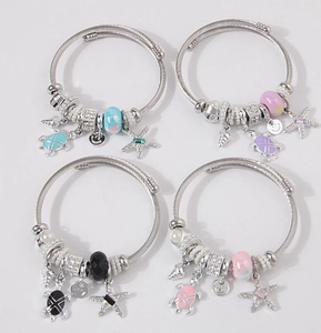 Detail of four-piece sea-themed bracelets with starfish, turtle, and shell charms
