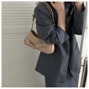 Mirror selfie showing the khaki underarm shoulder bag with double metal buckles decoration