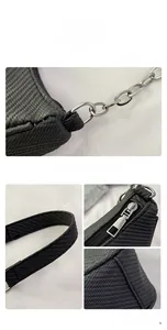 Detailed view of the black woven texture fabric and silver metal chain strap of the handbag