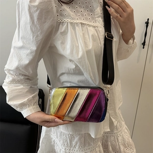 Metallic rainbow patchwork crossbody bag with wide black strap and striped design